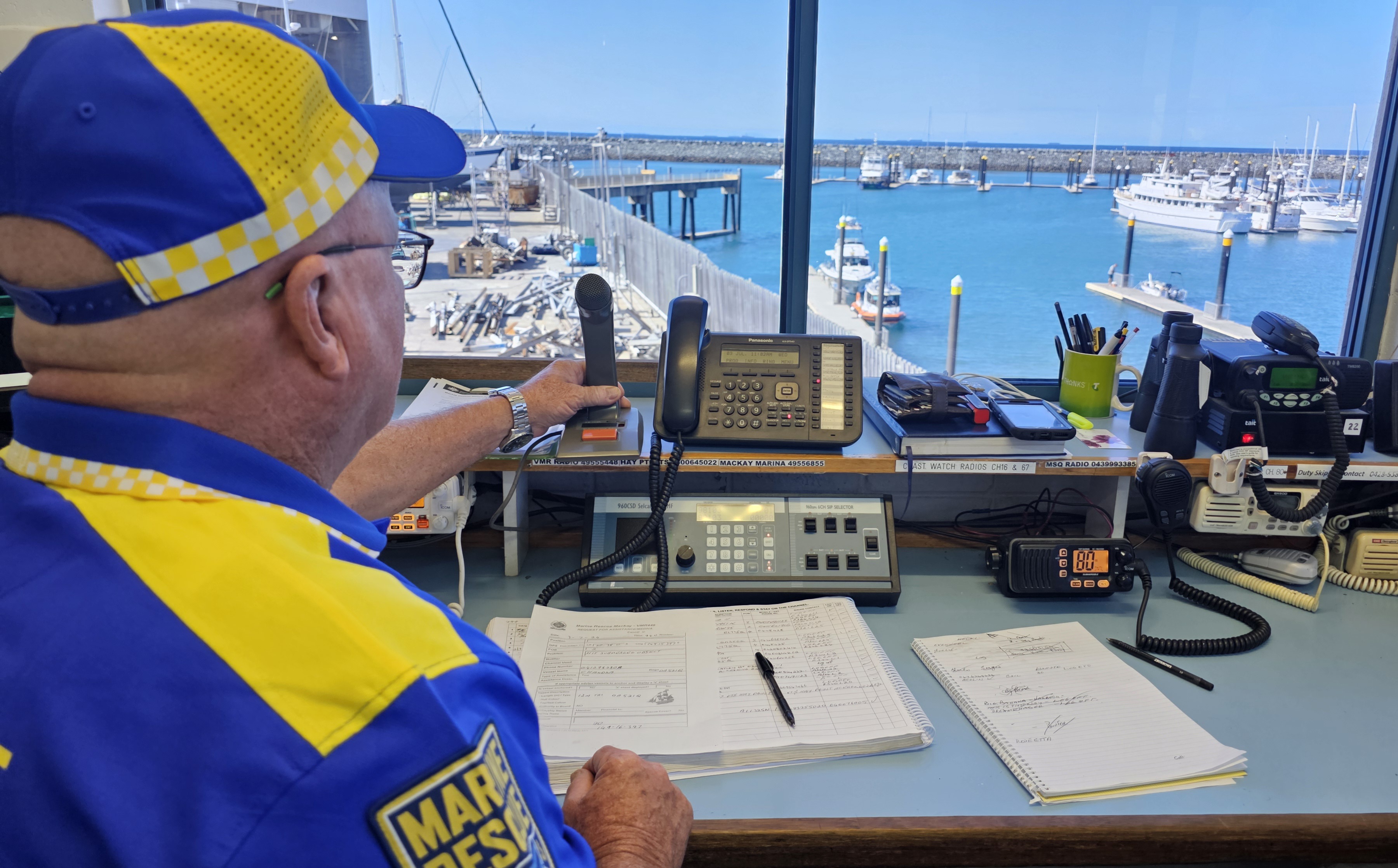 A radio room volunteer looks out onto the harbour