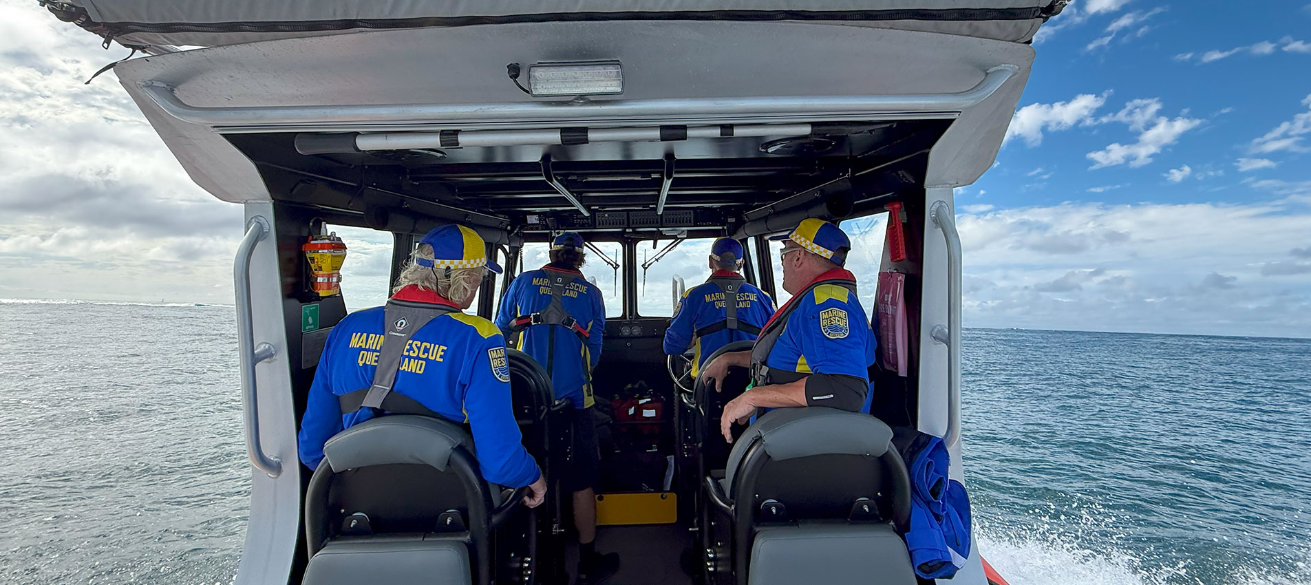 Marine Rescue Queensland volunteers on the water in a boat